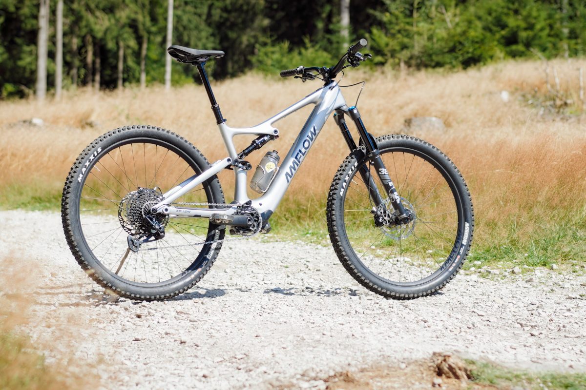 Mountain bike on a gravel path with grass and trees in the background