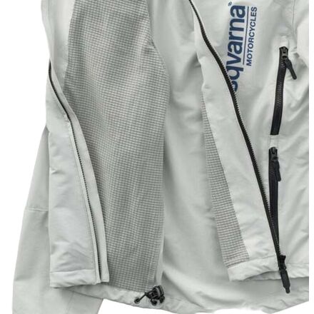A gray off-road motorcycle jacket with fleece lining, featuring a YKK zip fastener, reinforced seams, and reflective surfaces. The jacket has multiple pockets and is designed for windproof and water repellent properties.