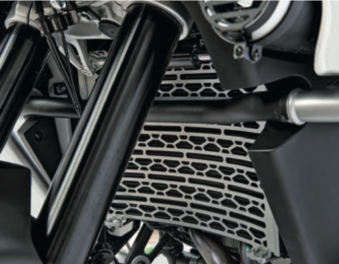 Close-up of a motorcycle exhaust system with a metallic finish. Radiator Guard-stainless Steel-Ibex 800