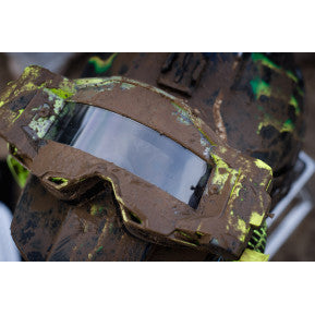 100% Armega / Armetic Forecast Goggle Roll-Off Film Kit on a muddy background.