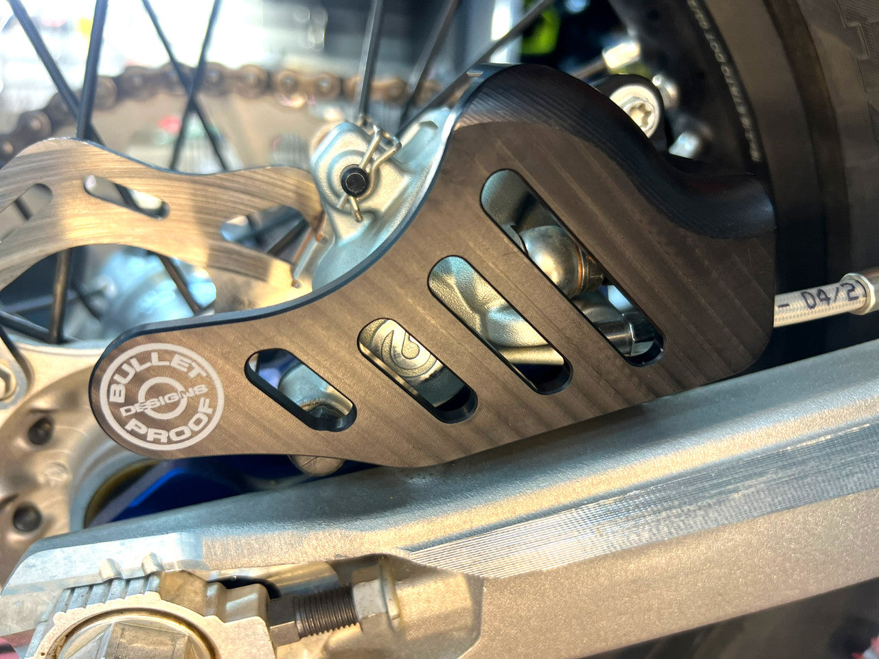 Bullet Proof Designs billet aluminum rear brake caliper guard for off-road motorcycles, fits BPD rear disc guards on KTM, Husqvarna, GasGas, Sherco, Yamaha, Honda, Beta, and Kawasaki bikes
