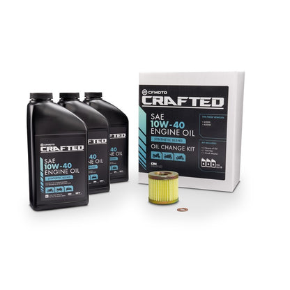 An oil change kit by CFMOTO CRAFTED, including three quarts of motor oil, an oil filter, and packaging.