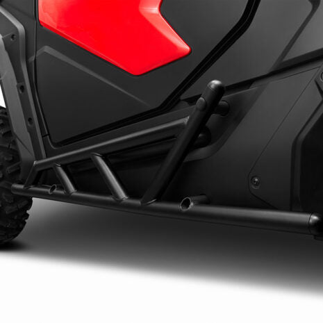 Close-up image of a black nerf bar attached to the lower side of a vehicle, designed for off-road use.