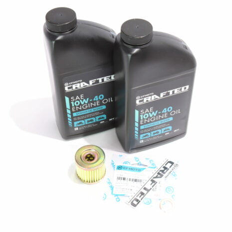 Two bottles of motor oil labeled 'CRAFTED' with a yellow oil filter and assorted service parts, all displayed on a white background.