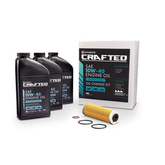 An oil change kit by CFMOTO CRAFTED, including three quarts of engine oil, an oil filter, and additional components.