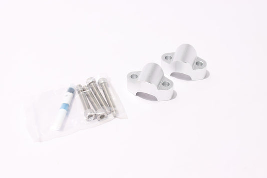 Set of white metal brackets and cylindrical components on a white background