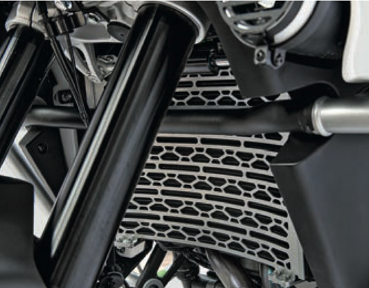 Close-up of a motorcycle exhaust system with a metallic finish. Radiator Guard-stainless Steel-Ibex 800