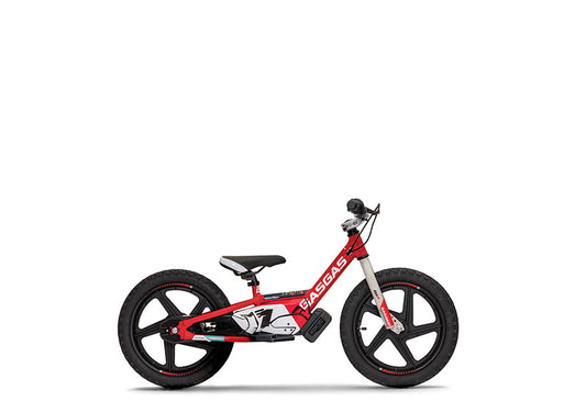 A red STACYC MC-E 1.16 balance bike with black wheels and BMX-style steel front fork.